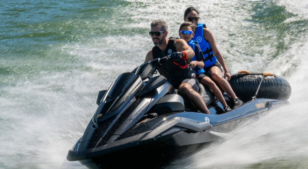 Yamaha WaveRunner FX cruising on water with family riding near Lake George Vermont